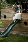 The bride goes down the slide first